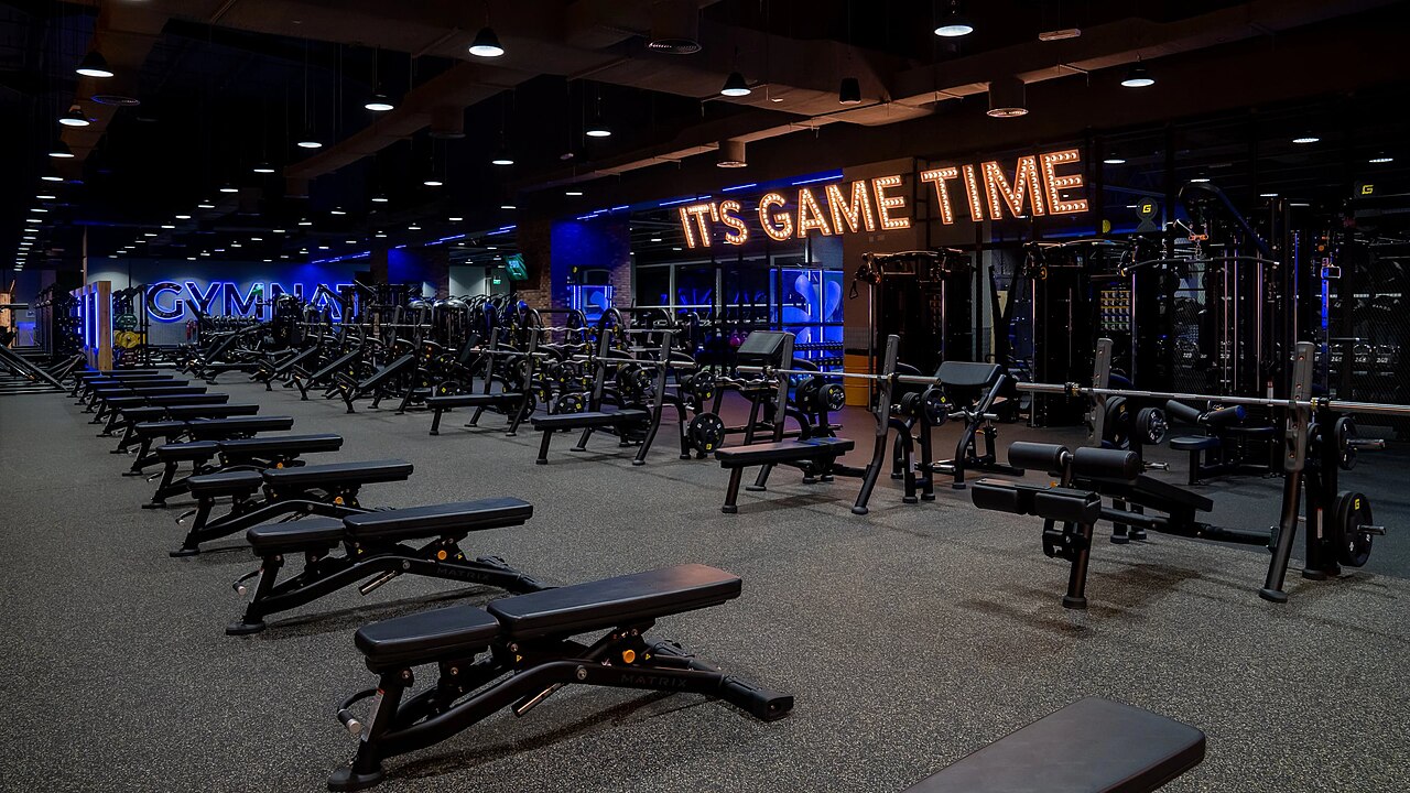 The interior of a gym with weight machines and free weights