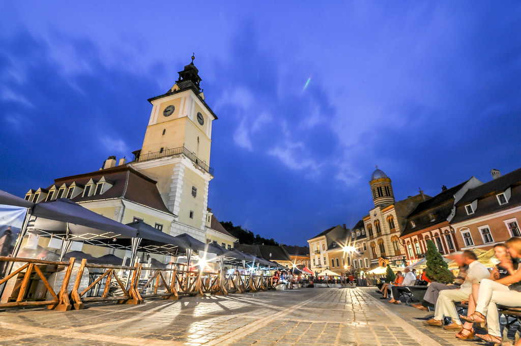 A European town square with a council house and café tables